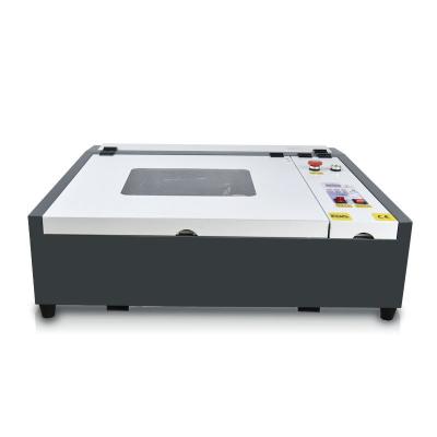 China Professional Design Gravograph Engraving Machine 4040 White-Black CNC Engraving Machine Full-enclosed for sale