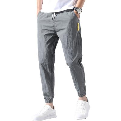 China Anti-wrinkle Summer Men's Casual Fashion Simple Nine-point Pants Loose Sweatpants Ultra-thin Waist Pants Men's Trousers for sale