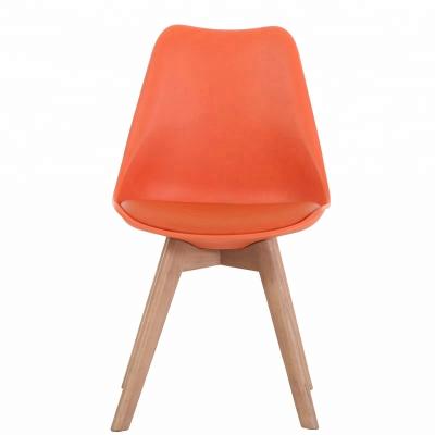 China Nordic Modern Home Decor Plastic Cushion Mid Century Furniture Leather Dining Chair With Solid Wood Cross Legs for sale