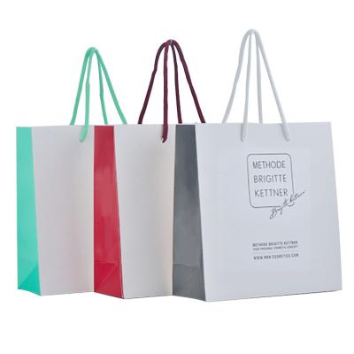 China Recycled Materials Custom Wholesale Handbags Apparel Tote Bags Mall Paper Shopping Bags With Customizable Logos for sale