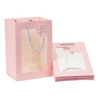 China Wholesale New Design Christmas Multi Colored Printed Decorative Laminated Paper Bags Recyclable With Ribblon Window And Handles for sale