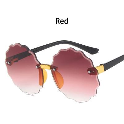 China Latest GLASSES Fashion Kids Rimless Wave Sunglasses Boys And Girls Round Sunglasses for sale