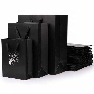 China Black Luxury Kraft Paper Gift Bags Recyclable Personalized Black Shopping Bag Packaging With Handle for sale