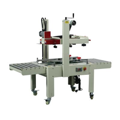 China FXJ6050 Manual Semi Automatic Food Top And Bottom Drive Flaps Folding Tape Box Cardboard Sealer Sealing Machine for sale