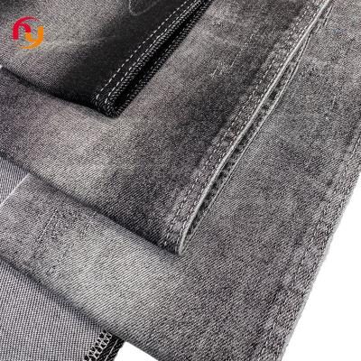 China Breathable high quality cloth denim material 380g black indigo color twill knitted High stretch cotton heavy raw Denim jeans fabrics for sale