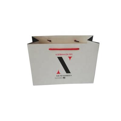 China Custom Handled Logo Luxury White Thick Cardboard Paper Bag for Boutique and Clothing Store for sale