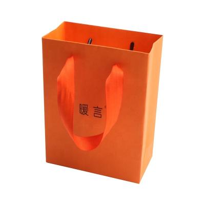 China New Handmade Logo Ribbon Rope Handles Hot Foiled Stamping Orange Matt Kraft Paper Bag With Gold for sale