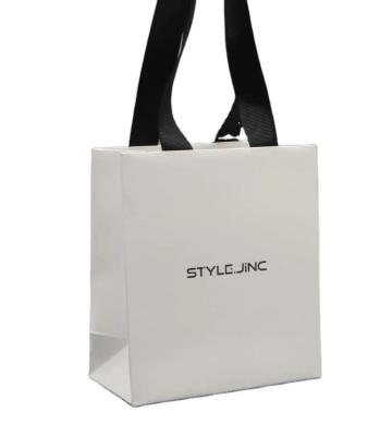 China Handmade white special paper bag with logo hotstamping black ribbon for gift packaging for sale