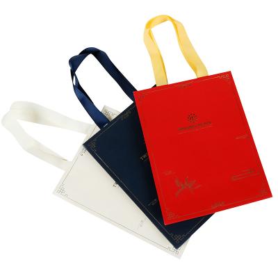 China Small Handmade Paper Bags For Jewelry Jewelry Paper Gift Bag With Ribbon Handle for sale