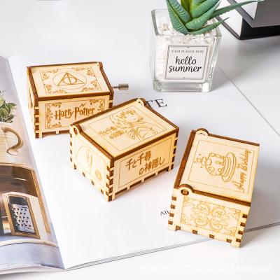 China Wooden Custom Multiple Designs Mechanical Classic Harry Potter Wooden Hand Crank Craft Music Box For Gift for sale