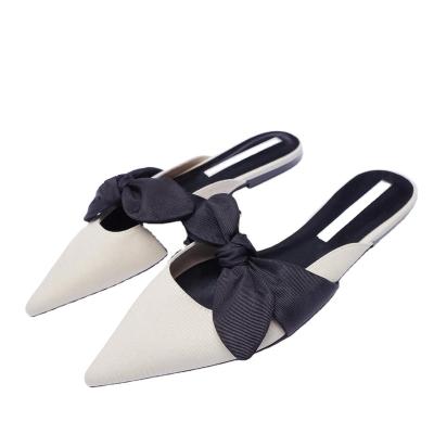 China Steel Toe High Quality Popular Women's Flat Shoes With Beige Bow Point Flat Heel Wear Simple Temperament Muller Shoes for sale