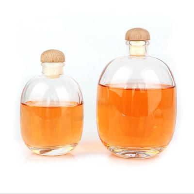 China 250ml 500ml Beverage Sprinkle Oval Clear Frosted Glass Fruit Wine Beverage Beverage Bottle With Wooden Cap for sale