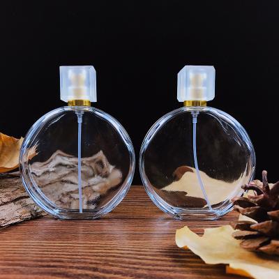 China Wholesale Fashionable Customization 100ml Falt Spray Bottle Glass Round Shape Glass Perfume Bottle Spray Bottle For Body Perfume for sale