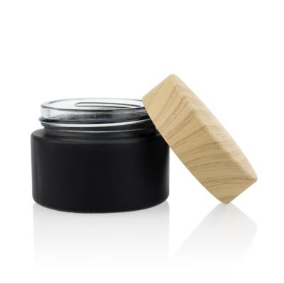 China Gift Frosted 5g 10g 15g 20g 30g 50g Black Glass Cosmetic Jar With Imitation Wooden Cap Cosmetic Bottle for sale