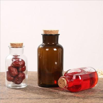 China Food Sealed 30ml 60ml 125ml 250ml 500ml 1000ml Clear / Amber Glass Storage Containers With Cork Stopper For Reagent Pill Apothecary Jar for sale