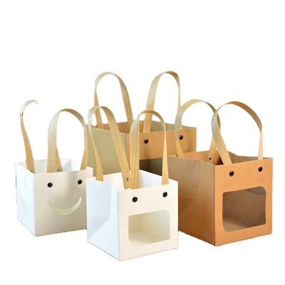 China Handled In Stock Paper Cute Smiley Mini Gift Square Kraft Paper Bag With Handle for sale