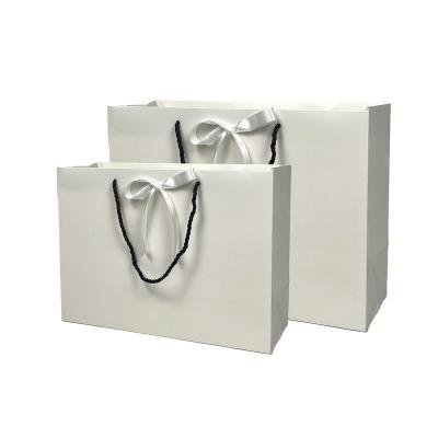 China Custom Logo Printing Folding Packaging Craft Recyclable Wholesale White Paper Bag Coated Paper Shopping Bag With Handle String for sale