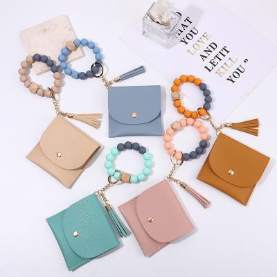 China Faux Fur Ball Pompom Chains Silicone Beaded Bracelet New Key Chain Women Coin Purse Change Wallet Pocket Card Holder With PU Tassel for sale