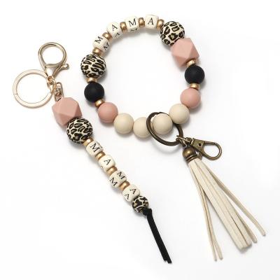 China Faux Fur Ball Pompom Chains Free Sample Custom Name 2pcs Set MOM Leopard Silicone Pearl Bead Key Chain Tassel Mother's Day Gift Wooden Bracelet Bangle for sale