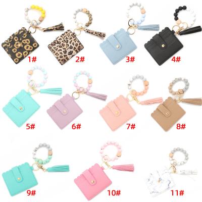 China Faux Fur Ball Pompom Chains Silicone Bead Bracelet Leopard Tassel Wallet Key Chain PU Leather Car Wristband Key Ring Credit Card Holder Keychain Set for sale