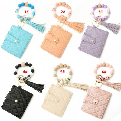 China Faux Fur Ball Pompom Chains Wholesale PU Leather Tassel Purse Key Chain Bracelet Silicone Beads Sewing Wallet Set For Women for sale