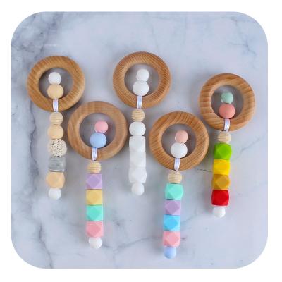 China DsorbabNon-Toxic Baby Wooden Teethers Bracelet Engraved Rings and Beads Baby Rattle Wooden Teeting Ring D021 for sale