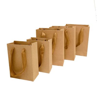 China Recycled Materials Logo Gift Paper Packing Bag Custom Craft Packaging Personalized Business Shopping Clothes Package Kraft Bags for sale