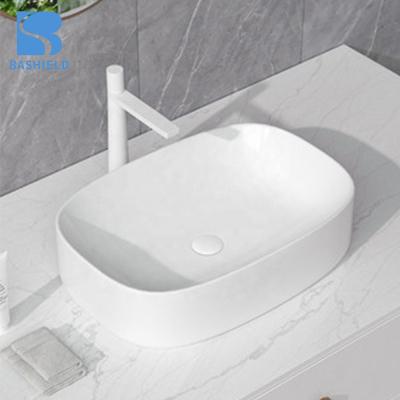 China Foshan Modern White Bathroom Sink New Design Ceramic Table Top Wash Basin for sale