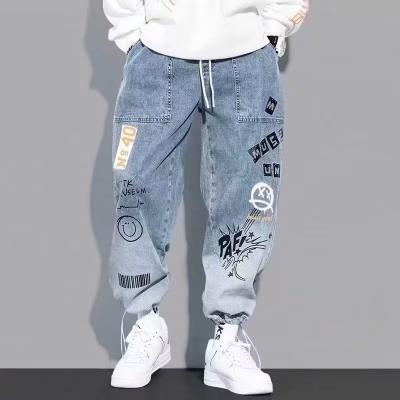 China 2023 autumn new breathable men's brand buckle jeans fashionable denim loose men's casual drawstring graffiti elastic waist harem pants for sale