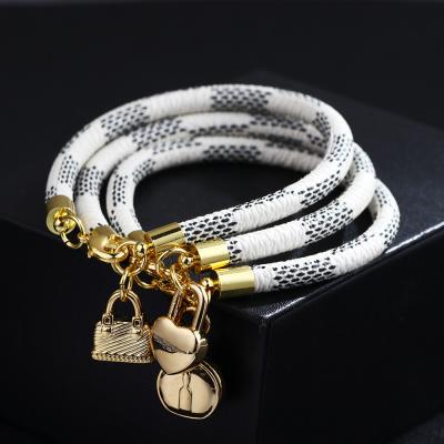 China Hot Environmental Friendly Style PU Striped Leather Bracelet Copper Buckle Gold Plated Round Lock Bag Bracelet for sale