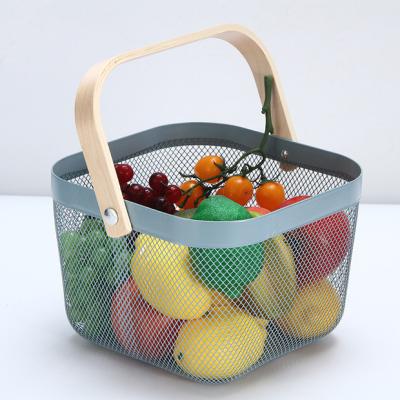 China Home Viable Storage Baskets Kitchen Bath Toy Metal Organizer Wire Mesh Fruit Storage Basket With Wooden Handle for sale