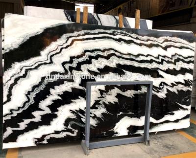 China Modern background backlit stone bookmatched panda white natural marble slabs for floor tile and wall tile for sale