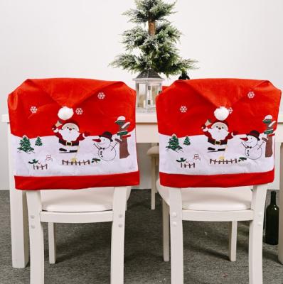 China Classic Non-Woven Fabrics Santa Claus Snowman Print Dining Chair Cover with Pom Pom Christmas Dinner Table Se 2021 for sale