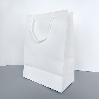 China Luxury Retail White Recycled Materials Kraft Paper Shopping Bags For Boutique for sale