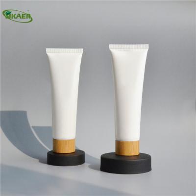 China Recycable Convenient Plug UV-Blocking Bamboo Screw Cap/PE Plastic Tube Empty Ointment Tube Facial Detergent Container Cosmetic Packaging for sale