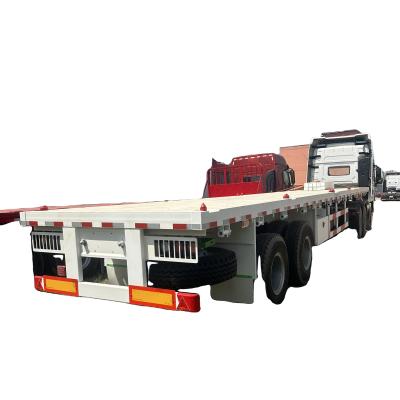 China Zambia Tri Axles 60 toneladas de semirremolque de cama plana para el transporte de contenedores FT de 20/40 pies en venta