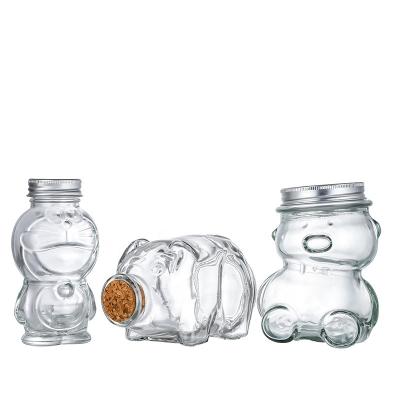 China Drink Food Storage Jar Cartoon Shape Glass Bottle 140ml 175ml 165ml 350ml Bear Kitty Doraemon High Quality Clear Candy Snack Jar for sale