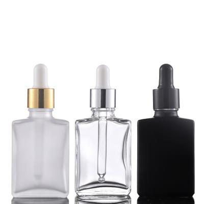 China Used for packing essences for spotting cosmetic packing materials filled empty mute black frosted glass bottle 30ml bottle transparent flat square dropper for sale