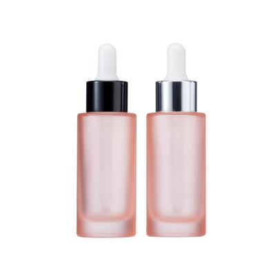 China Used to pack essences cosmetic packaging materials filled empty bottles anodized aluminum plastic pink head 30ml essence glass dropper bottle for sale