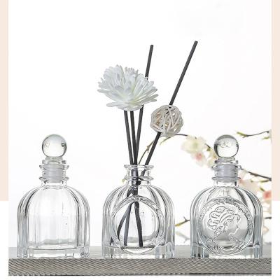 China Eco-friendly Factory Produced Home Decor Perfume Oil Diffuser Bottle Luxury Clear Embossed Aroma Round Glass Diffuser Bottle 100ml for sale