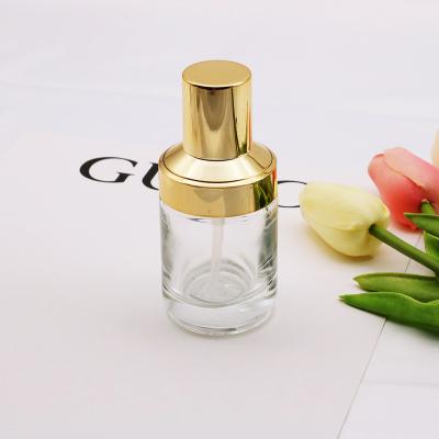 China Hot Selling Eco-friendly Custom Round Cream Lotion Toner Glass Bottles 40ml 120ml Clear Color Cosmetic Glass Bottle With Gold Cap for sale