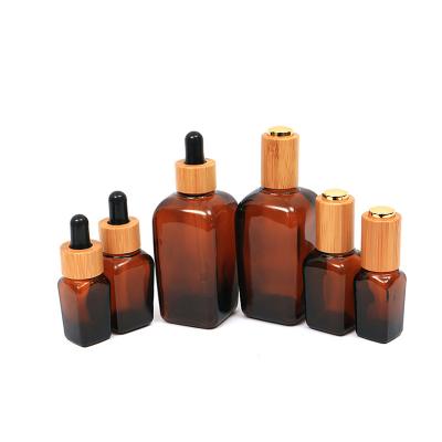 China Wholesale Eco-friendly Cosmetic Glass Wooden Bottle Amber Brown Custom Square Essential Oil Serum Bottle 30ml Dropper Bottle With Bamboo Dropper for sale