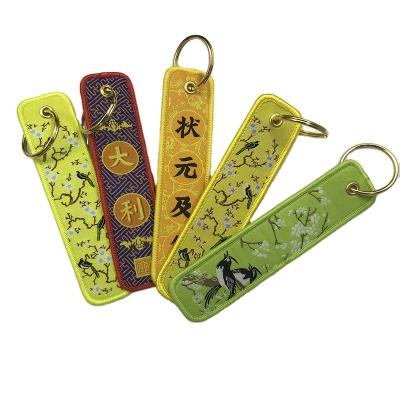 China 100% Polyester Material 2021 New Stains Creative Embroidery Pattern Customizable Wheat And Funny Leather Weaving Key Chains for sale