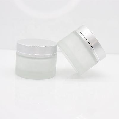 China Customized 50g personal care frosted clear glass bottle for cosmetic jars/50g cosmetic cream container screw cap for sale