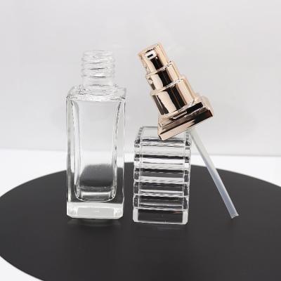 China Wholesale Empty 40ml Rose Gold Luxury Pump Square Lotion Bottle Clear Cosmetic Glass Cosmetic Container for sale