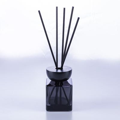 China Luxury Home Aroma Oil Rectangle Glass Perfume Bottle Empty Transparent Black Color Diffuser Oil With Tubular Diffuser And Wooden Lid for sale