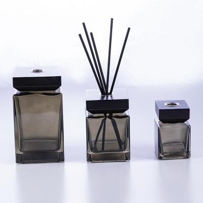 China Wholesale Empty Transparent Black Luxury Rectangular Perfume Diffuser Glass Tubular Home Oil Diffuser Bottle With Wooden Lid for sale