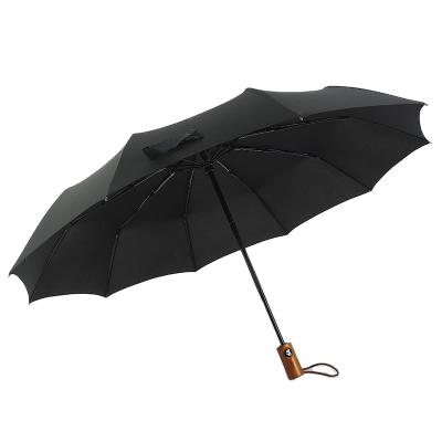 China Minimalist Creative 10 Bones With Wooden Handle In Half For Business Advertising Full Automatic Folding Umbrella for sale