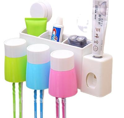 China Viable Creative Plastic Wall Mounted Toothbrush Holder 3 Cups With Toothpaste Dispenser Toothbrush Storage Set for sale