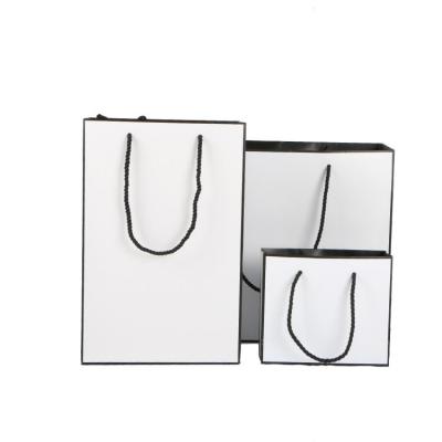 China Custom Recycled Materials Logo Wholesale Luxury White Shopping Paper Bags With Handle for sale